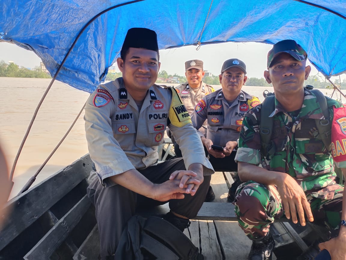 Sinergitas TNI-POLRI  mengarungi Sungai Reteh  menggunakan sampan